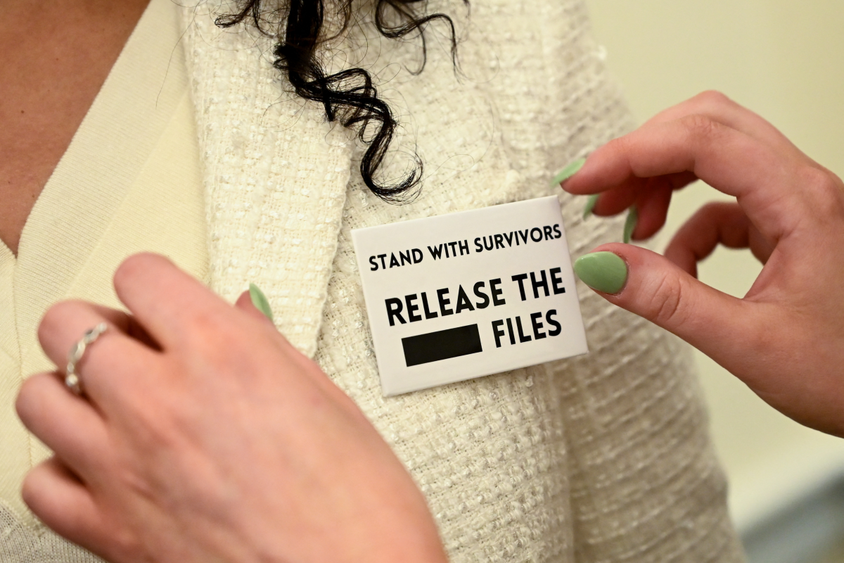 A woman wears a 'Release The Files' pin at a press event with survivors of convicted sex offender Jeffrey Epstein, held by the Democratic Women's Caucus in advance of President Donald Trump's State of the Union address on Capitol Hill in Washington DC on February 24, 2026.