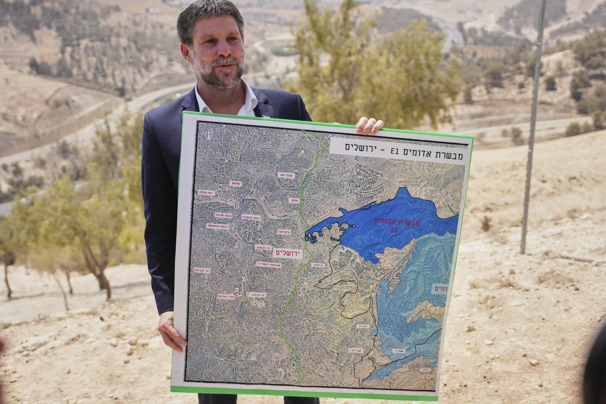 Israeli Finance Minister Bezalel Smotrich holds a map that shows the E1 settlement project during a press conference near the settlement of Maale Adumim, in the Israeli-occupied West Bank, Aug. 14.