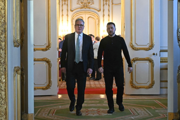 Britain's Prime Minister Keir Starmer (L) and Ukraine's President Volodymyr Zelensky (R) head to a private room to hold a meeting during a summit at Lancaster House on March 2 in London, England.