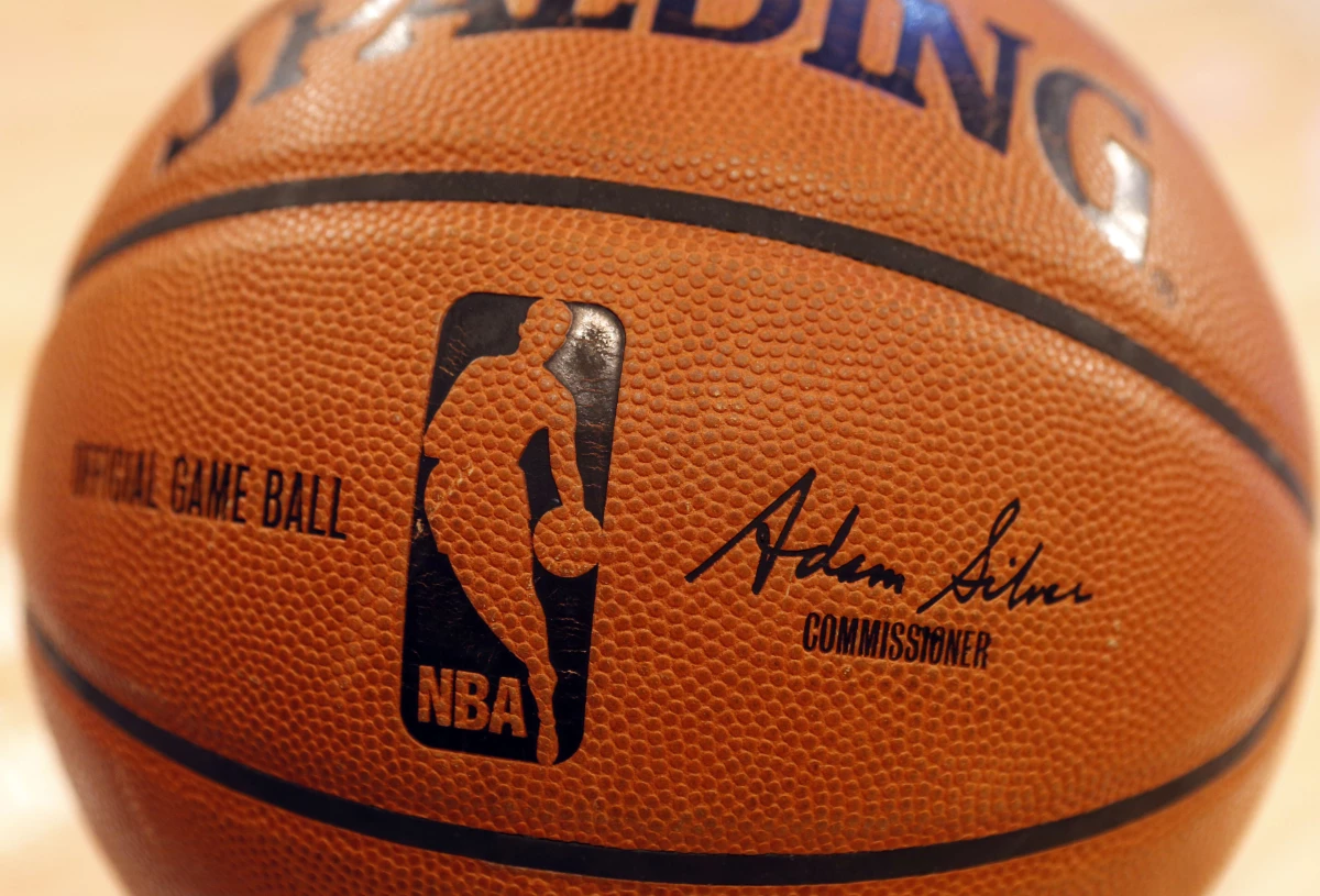 An NBA logo is seen on an official game ball before a game, Feb. 1, 2014, in New York. The NBA said Wednesday that it is not accepting Warner Bros. Discovery's $1.8 billion per year offer to continue its longtime relationship with the league and therefore has entered into a deal with Amazon Prime Video.