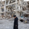 A man walks among buildings destroyed by strikes in Tehran during a joint U.S.-Israeli war in Iran, on Monday.