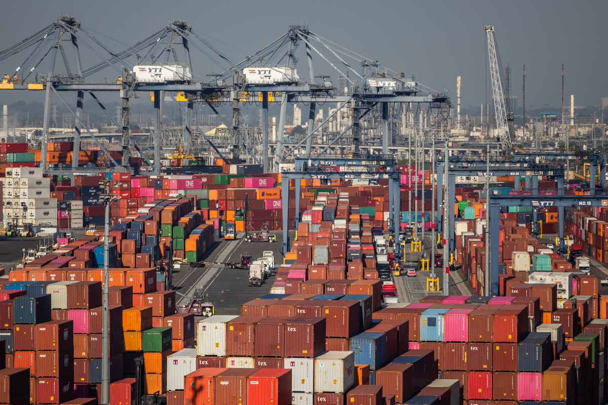 Gantry cranes, shipping containers and trucks are seen inside the Port of Los Angeles in San Pedro, California