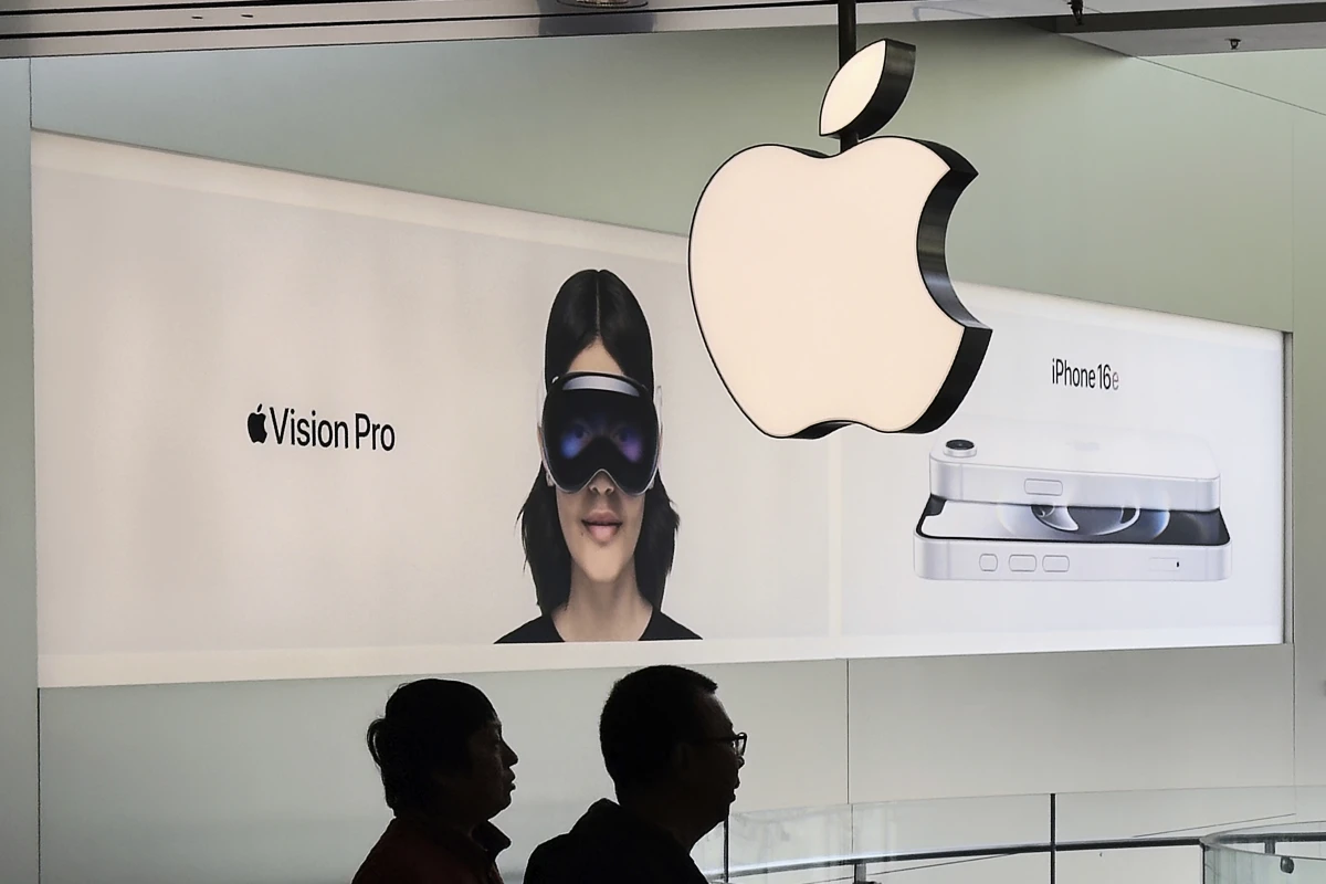 Customers visit an Apple Store in Beijing, April 10.