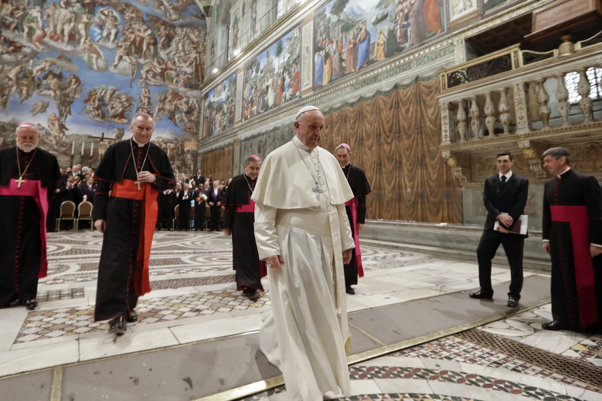 Pope Francis leaves after taking a family photo with diplomats accredited to the Holy See inside the Sistine Chapel at the end of an audience for the traditional exchange of New Year greetings at the Vatican on Jan. 8, 2018.
