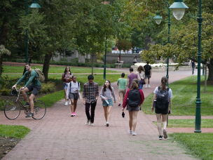 Students walk to and from classes on the Indiana University campus in Bloomington, Ind., in 2021.
