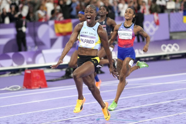 Julien Alfred, of St. Lucia, celebrates after winning the women's 100-meters final at the Paris Olympics, Saturday, Aug. 3, 2024, in Saint-Denis, France.