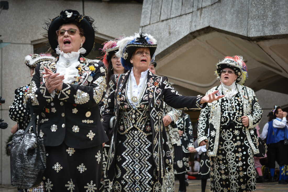 Pearly Kings and Queens, known as Pearlies, are an organised charitable tradition of working class culture in London, England. The practice of wearing clothes decorated with mother-of-pearl buttons is first associated with Henry Croft, an orphan street sweeper who collected money for charity. In the late 1870s, Croft adapted this to create a pearly suit to draw attention to himself and aid his fund-raising activities. Each group of Pearly Kings and Queens is associated with a church in central London and is committed to raising money for charities.
