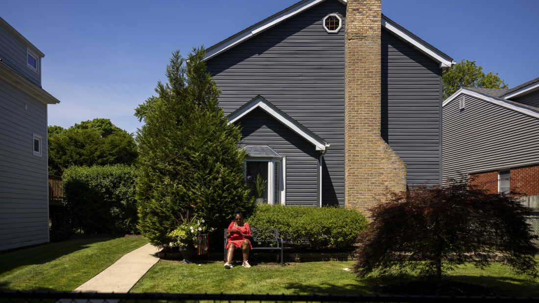 Reparations recipient Kimberly Holmes-Murphy sits outside her home in Evanston, Ill. Holmes-Murphy is a grantee of the city’s Local Reparations Restorative Housing Program designed to compensate Black residents for decades of systemic discrimination.
