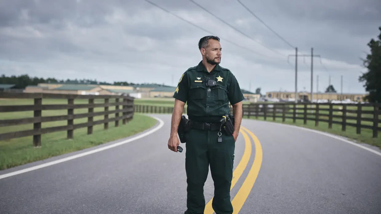 Walton County Sheriff's Office Sgt. Oscar D'Lassalas, 40, an officer certified to enforce federal immigration law, stands on the road to the jail where undocumented people are held for federal Immigration and Customs Enforcement agents to pick up. The sheriff's office in this Florida Panhandle city has partnered with ICE.