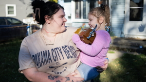 Jayeleauna Lewis, a singe mother, spends time with her 3-year-old daughter, Gianna, outside their home in Indianapolis, Indiana, Saturday, October 3, 2026. Jayeleauna says she became a victim of fraud after someone stole her EBT SNAP card number and used it to make unauthorized purchases in several states. Octavio Jones for NPR