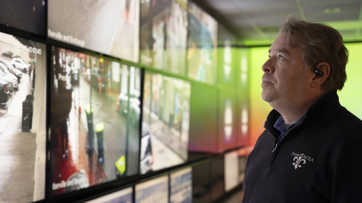 Bryan Lagarde, founder of Project NOLA, stands in front of a wall of screens displaying feeds from the nonprofit's extensive crime camera network at its headquarters in New Orleans on Dec. 4. The system monitors thousands of cameras citywide to assist law enforcement and enhance public safety.
