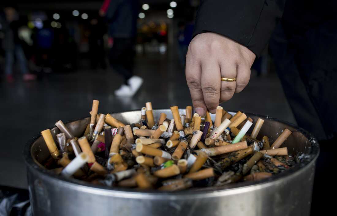 In this photo taken on February 28, 2017, a man grinds out his cigarette in an ashtray at a railway station in Shanghai. Shanghai widened its ban on public smoking March 1 as China's biggest city steps up efforts to stub out the massive health threat despite conflicts of interest with the state-owned tobacco industry.