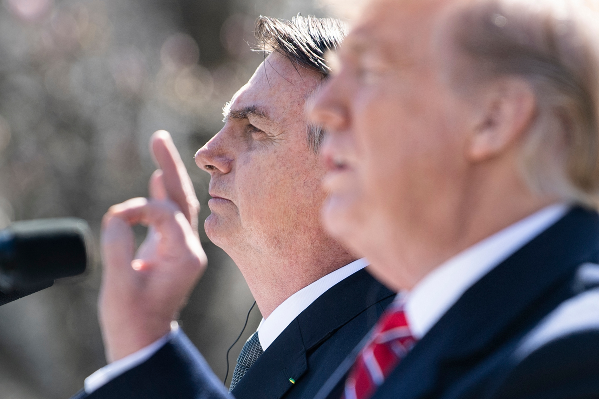 Brazil's President Jair Bolsonaro listens while US President Donald Trump speaks during a press conference in the Rose Garden of the White House March 19, 2019, in Washington, D.C.