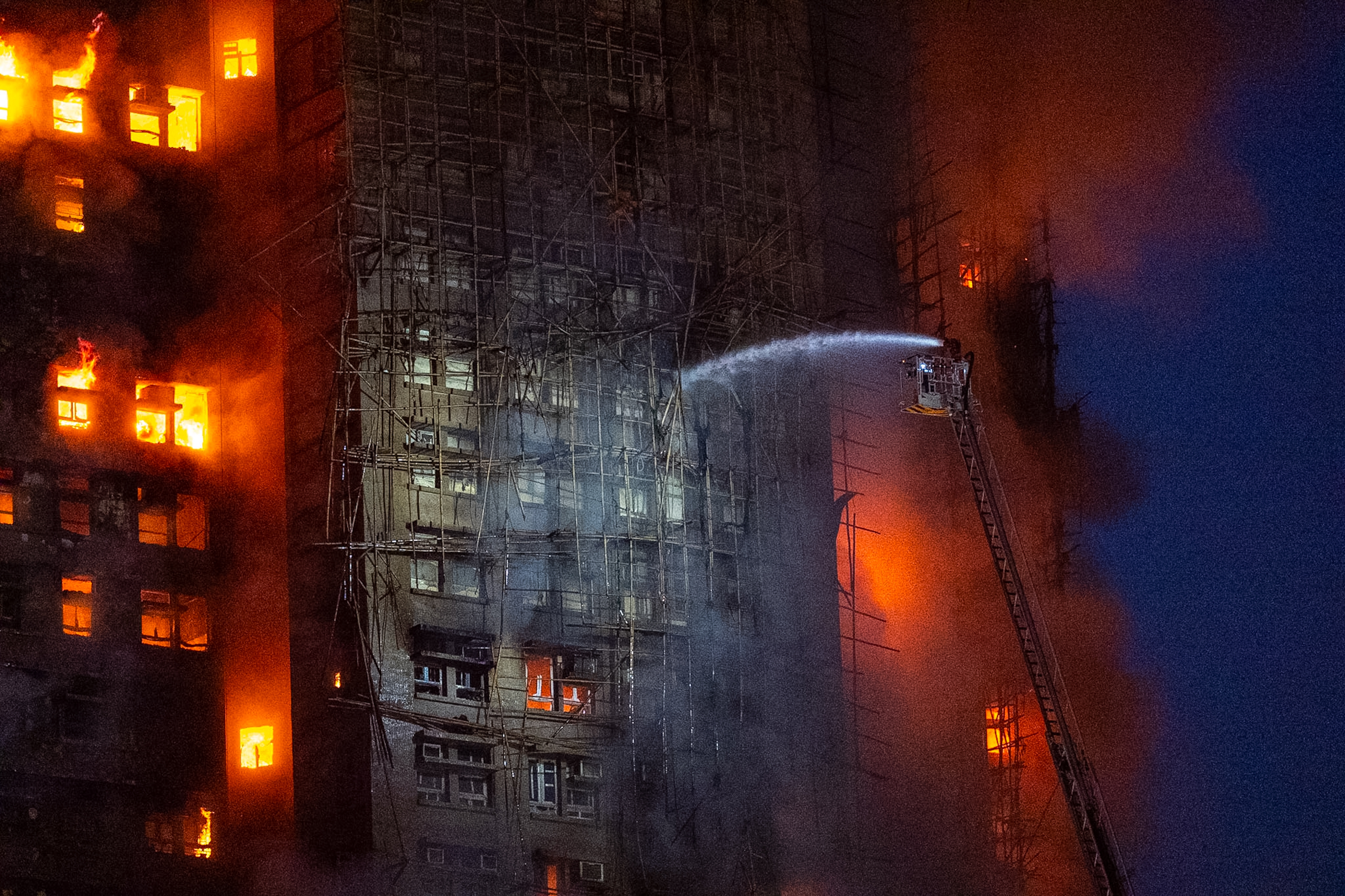 Firefighters work to extinguish a fire which broke out at Wang Fuk Court, a residential estate in the Tai Po district of Hong Kong