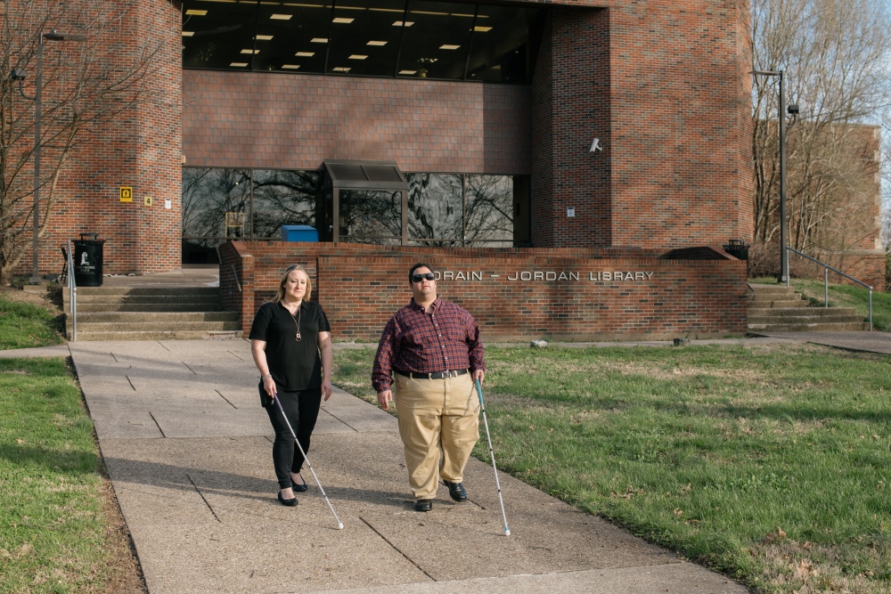 Miranda Lacy and Harold Rogers walk around the campus of West Virginia State University, where both completed undergraduate degrees. They consider the campus a second home because staff there worked hard to make sure their education was accessible. Now, they're in a graduate program that they say has failed to make their learning materials accessible and have filed a lawsuit.