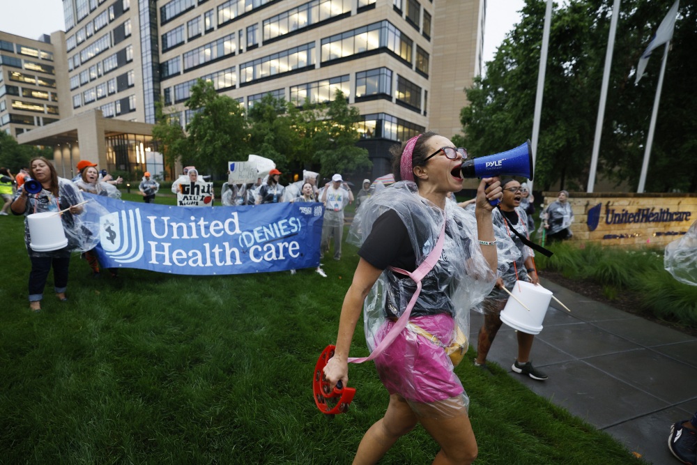 Health care advocates are shown protesting care denials at UnitedHealthcare's offices on July 15, 2024 in Minnetonka, Minnesota. (Getty Images for People's Action Institute)