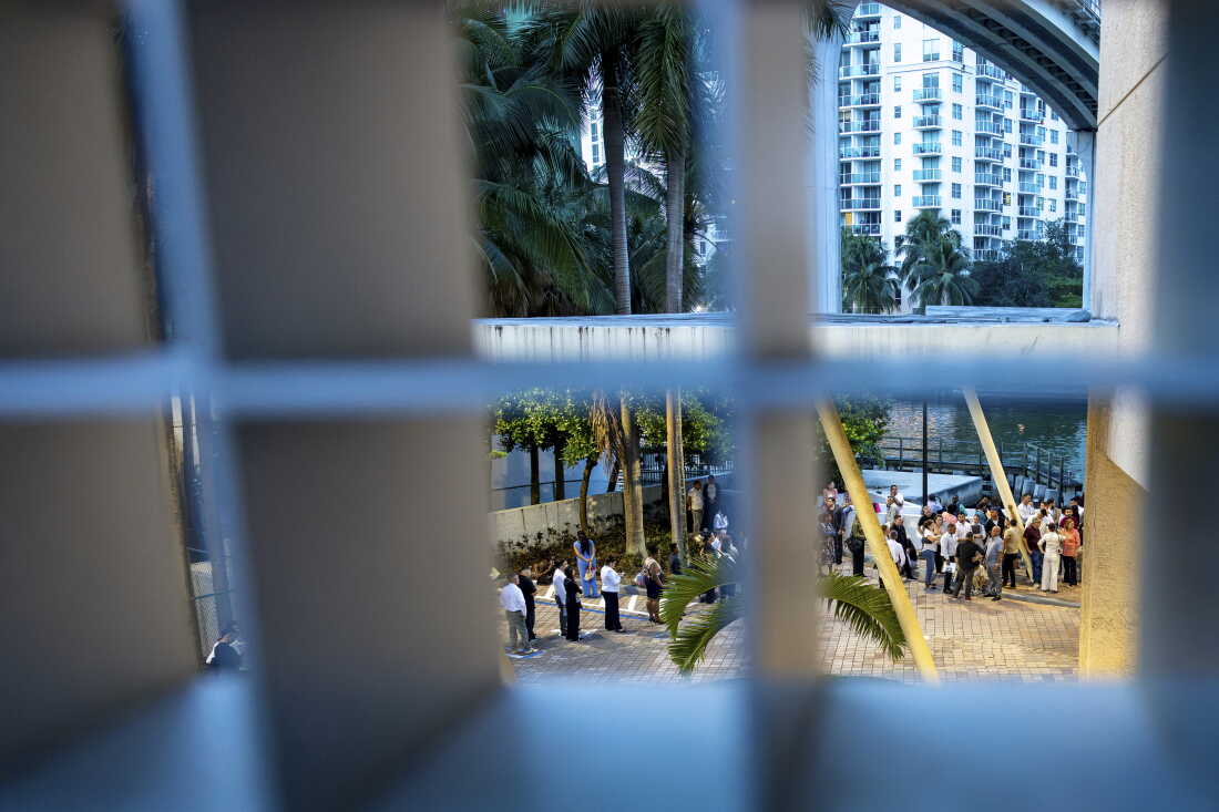People wait outside the Miami Immigration Court on Wednesday, Sept. 2, 2026 in Miami, Fla.