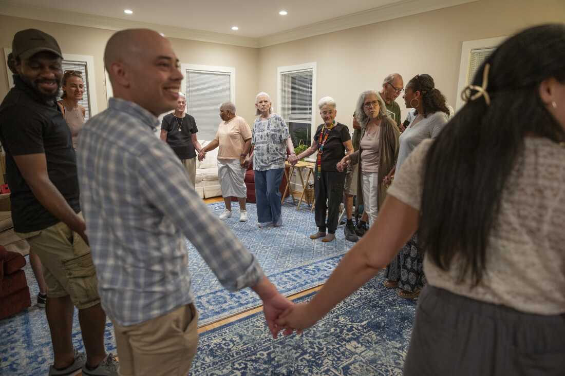 Former residents, current residents and friends of Anne Montgomery House prepare to dance a traditional Greek dance at the farewell celebration in Washington, D.C. on July 31, 2026. The community house that is closing after a decade was run by Society of the Sacred Heart, an international congregation of Roman Catholic religious women.