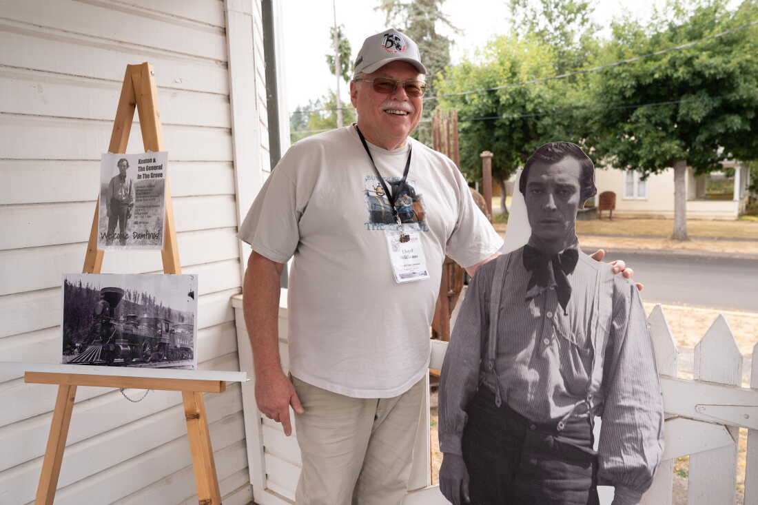 Lloyd Williams of the Cottage Grove Historical Society poses in front of the Cottage Grove Museum in Cottage Grove, Ore., on Sunday, Aug. 29, 2026. Williams is the Chair of the 2026 Buster Keaton Convention. (Krista Rossow for NPR)