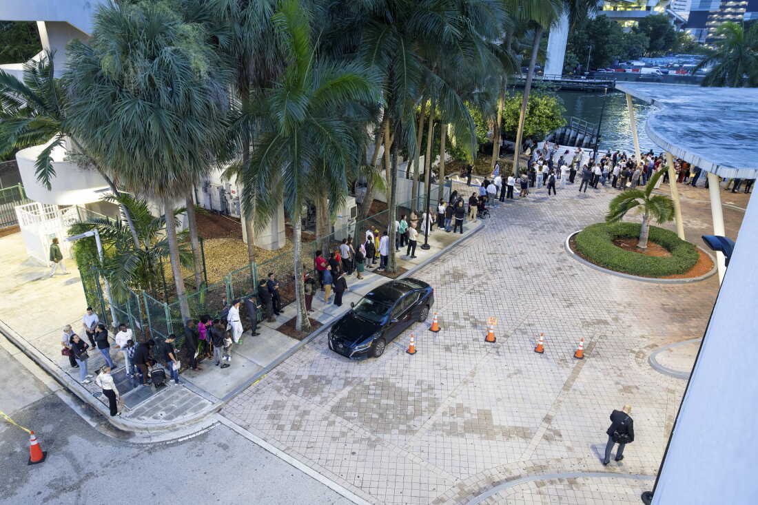 People wait outside the Miami Immigration Court on Wednesday, Sept. 2, 2026 in Miami, Fla. Eva Marie Uzcategui for NPR