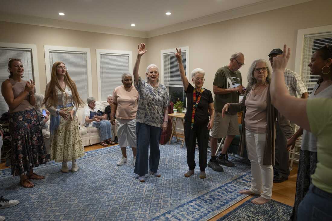Former residents, current residents and friends of Anne Montgomery House prepare to dance a traditional Greek dance at the farewell celebration in Washington, D.C. on July 31, 2026. The community house that is closing after a decade was run by Society of the Sacred Heart, an international congregation of Roman Catholic religious women.