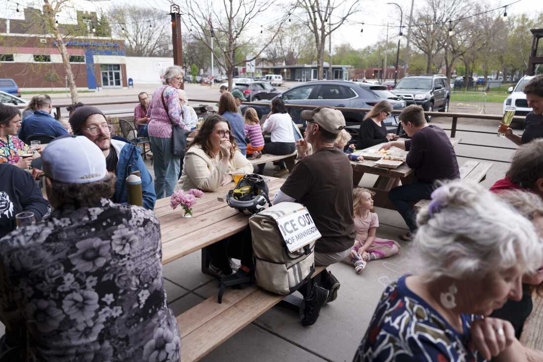 Guests mingle on a patio during a mutual aid fundraiser hosted by Juntos Podemos at Arbiter Brewing Company in Minneapolis, Minn. on April 23, 2026. The event raised around $15,000 dollars to support community members who continue to be impacted by federal immigration enforcement in the aftermath of Operation Metro Surge.