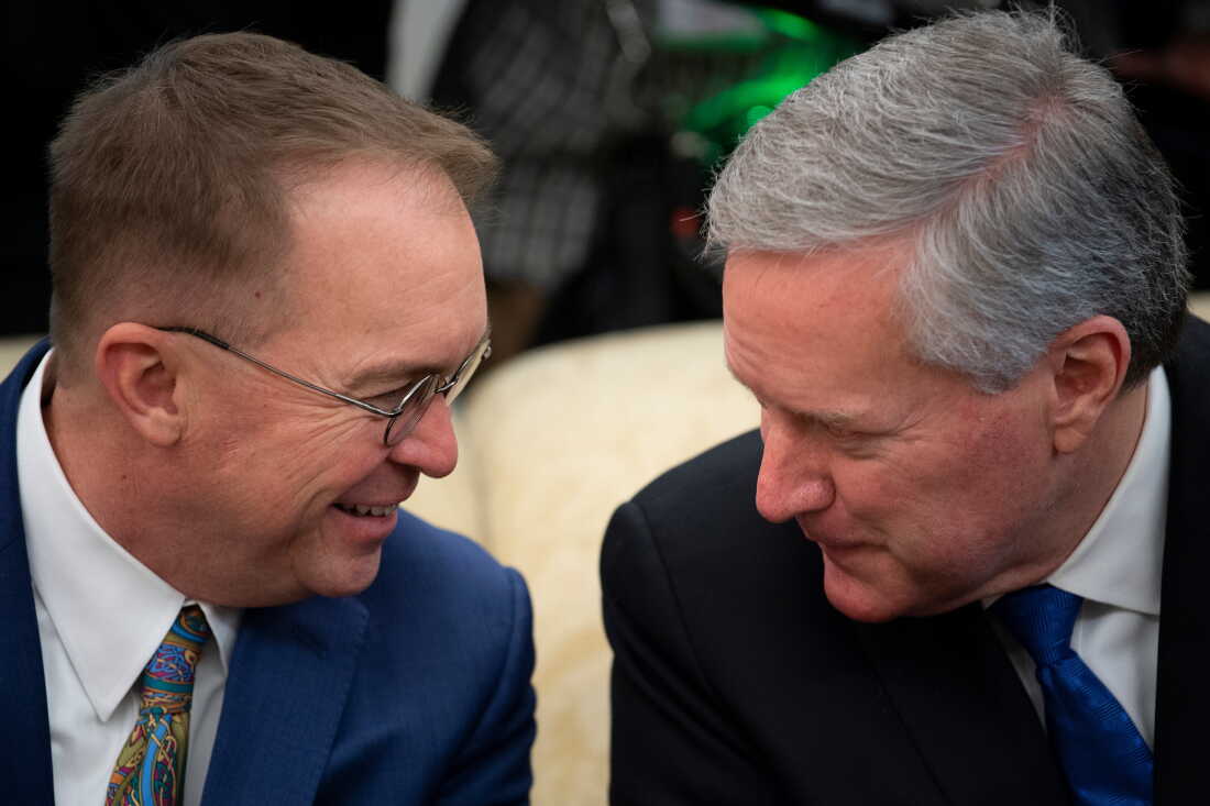 Then-White House Chief of Staff Mark Meadows sat alongside former White House Chief of Staff Mick Mulvaney before a meeting in the Oval Office on March 12, 2020, in Washington, DC. - US President Donald Trump defended his decision to announce a suspension on arrivals from the EU without informing European governments, telling reporters Thursday there wasn't enough time.His remarks came after the presidents of the European Commission and European Council reacted with anger to the suspension Trump announced "unilaterally and without consultation" on Wednesday."I didn't want to take time," Trump told reporters in the Oval Office when asked about the criticism. "It takes time... We had to move quickly." (Photo by Brendan Smialowski / AFP) (Photo by BRENDAN SMIALOWSKI/AFP via Getty Images)