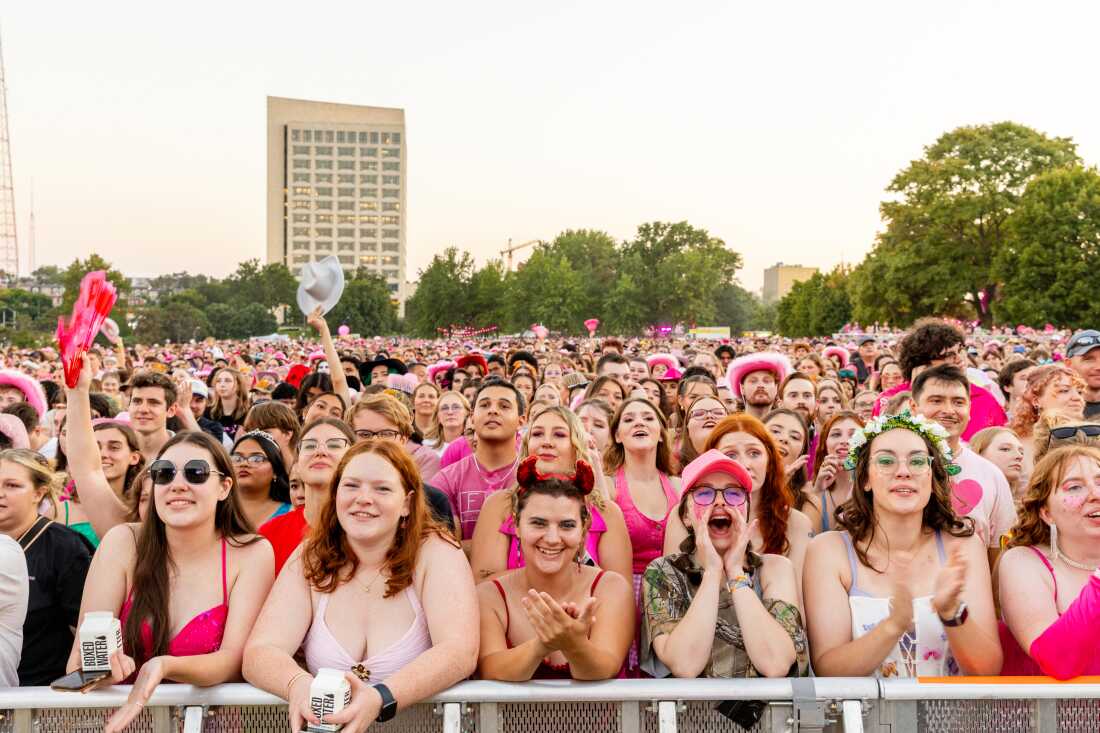 Concert-goers watch drag performers open for Chappell Roan.