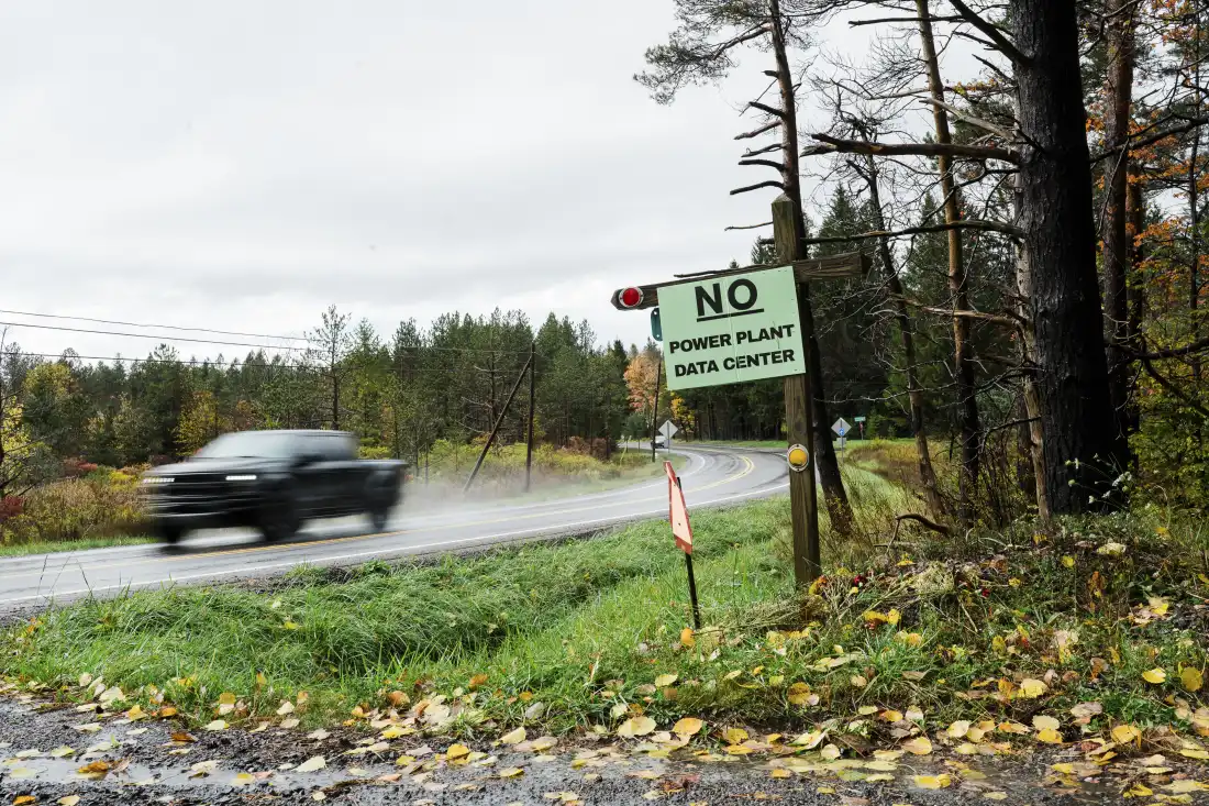 A motorist drives past a “No Power Plant Data Center” sign in Canaan Valley, W.Va. (Chris Jackson/For NPR)