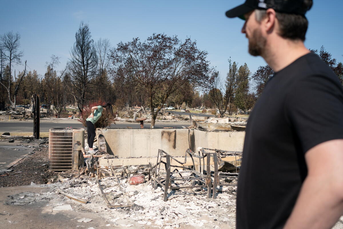 Spokane wildfire evacuees return home, but it's 'still a hazmat situation' 1 Melissa and Chris Matthews examine the remains of their family home in Spokane on August 14, 2026.