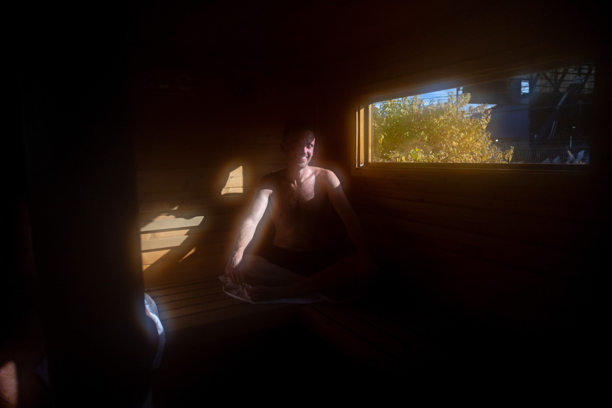Michael Calcagno, of Seattle, sits inside a mobile sauna, during the Seattle Sauna Festival. Sauna enthusiasts often report a mental health boost after time spent soaking in the hot air.