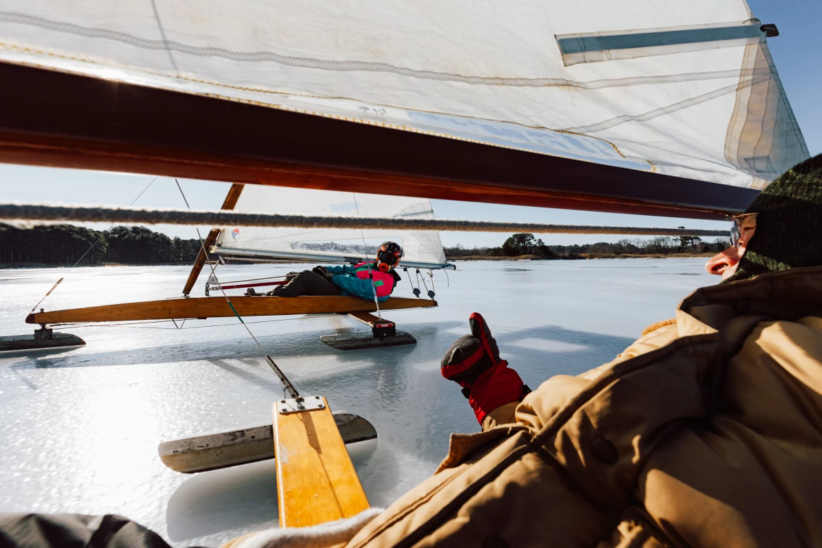 Mike Keene (right) gives a thumbs up to Keith Powers. In part because of the near-frictionless ride, ice boats move at more than three times the speed of the wind. That makes for thrilling — if sometimes dangerous — rides that ice boaters call 'addictive.'