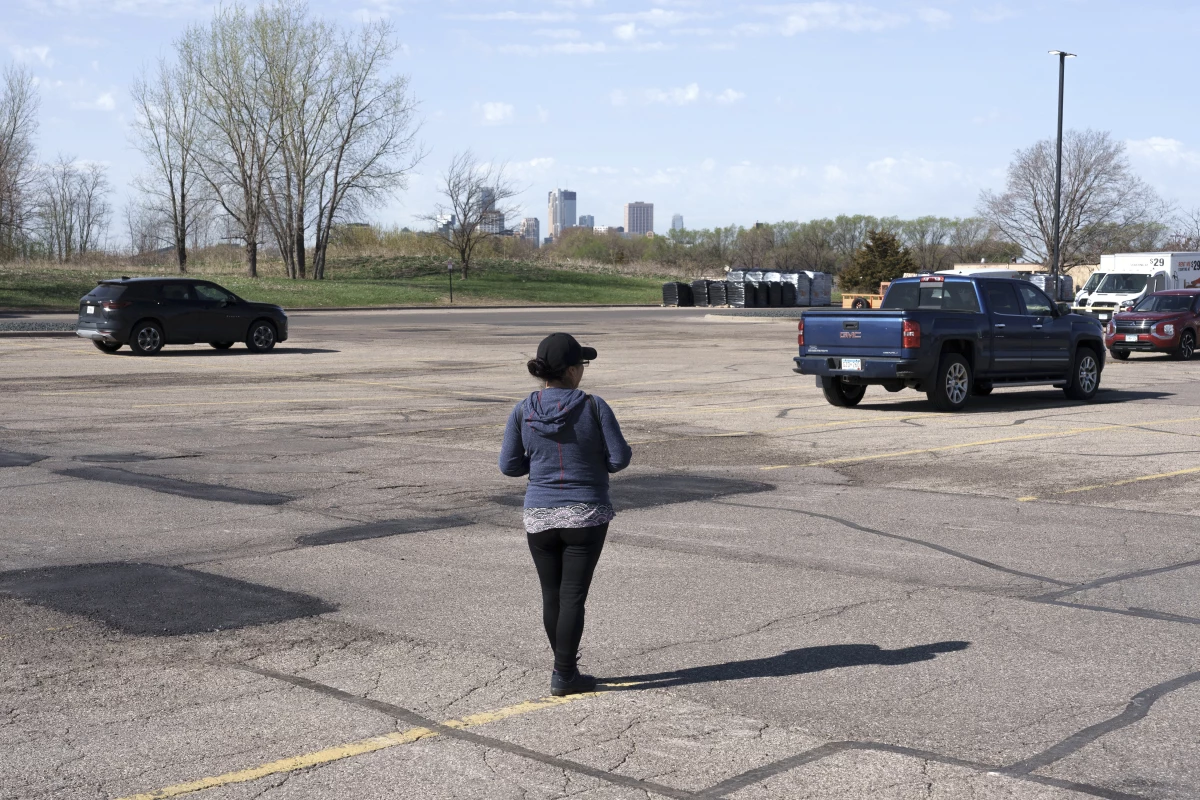 R, a day laborer from Ecuador who cleans houses for a living, waits for work outside a Home Depot in the Twin Cities, Minn. on April 22, 2026. Although she has returned to work following Operation Metro Surge, R has seen both a decline in work opportunities as well as a decrease in hourly wages being offered.