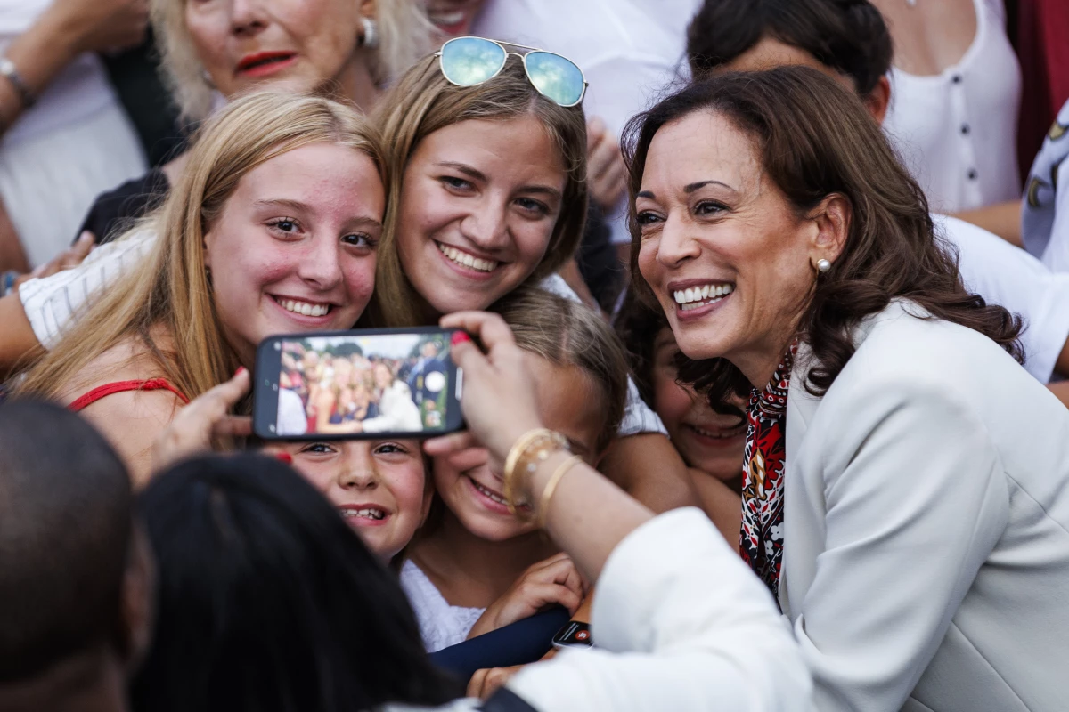 Vice President Harris takes selfies with guests during an Independence Day event on the South Lawn of the White House on July 4, 2024.