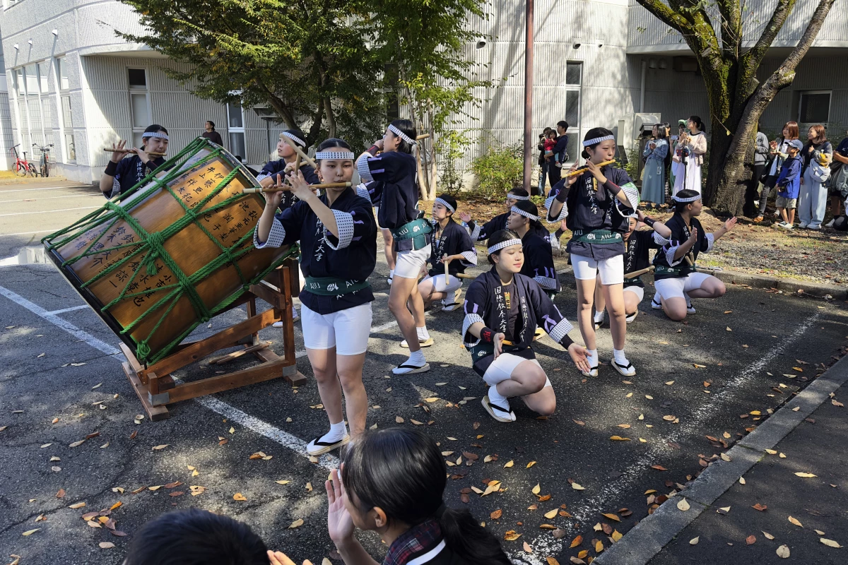 Female musicians play drums and flutes at a kanto performance in Japan's Akita Prefecture.