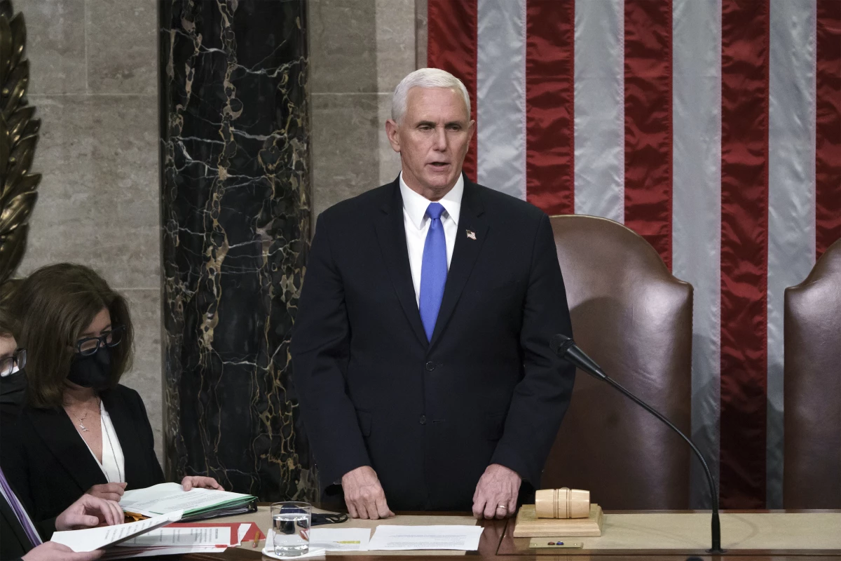 Then-Vice President Mike Pence reads the final certification of Electoral College votes after the Jan. 6 Capitol riot in 2021. A new law clarifies that the vice president's role in the counting of electoral votes is ministerial. Congress will count the votes from the 2024 presidential election on Monday.