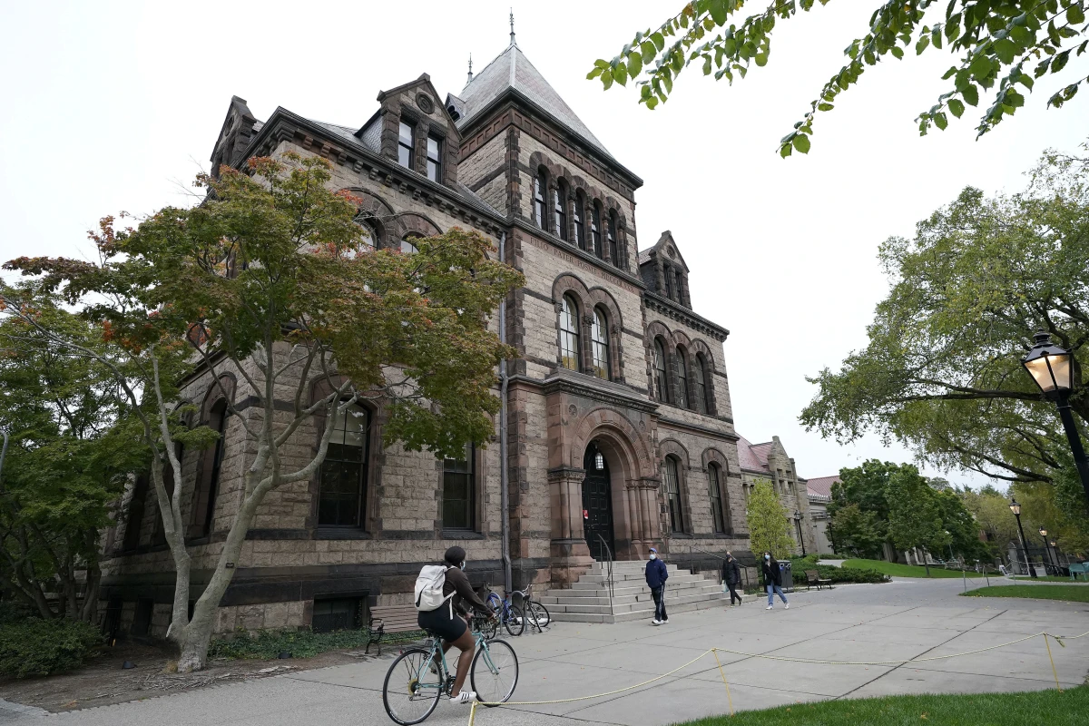People are seen traversing the Brown University campus in Providence, R.I., Oct. 12, 2020.
