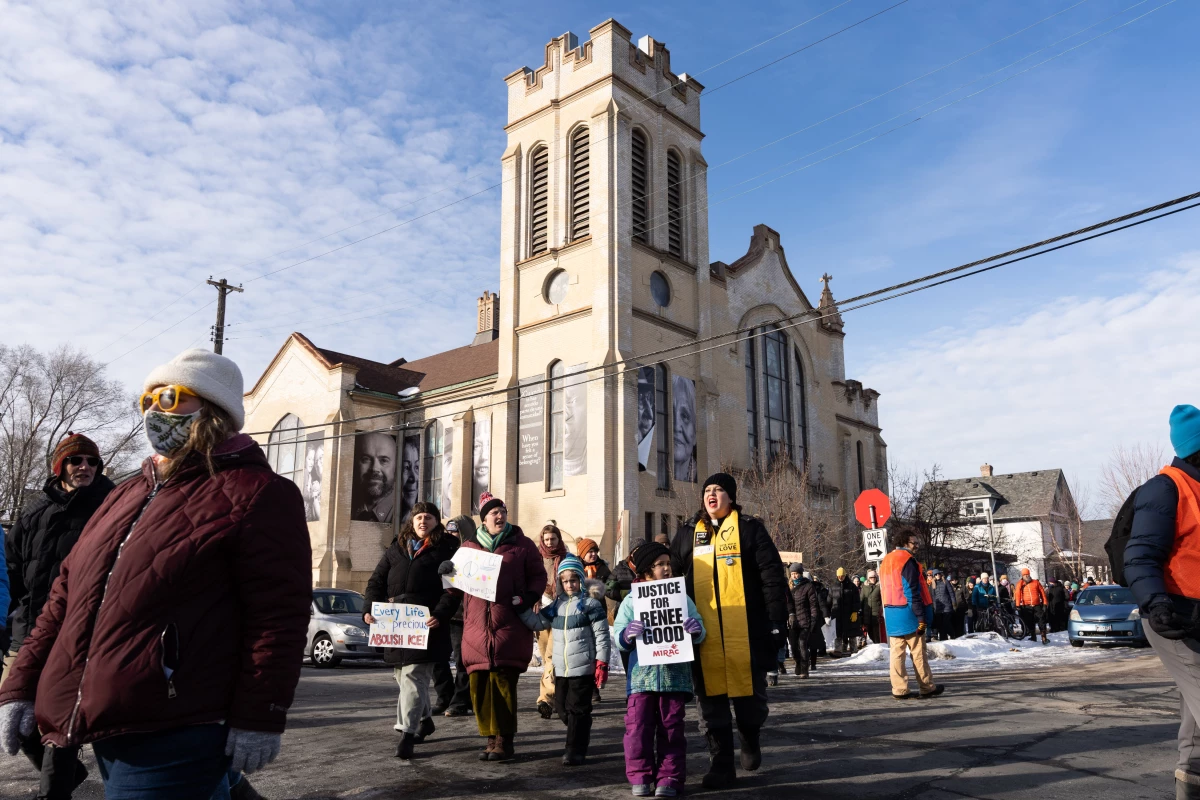 Rev. Ashley Horan and her daughter Eden, 5, march from St. Paul's-San Pablo Lutheran Church during a singing vigil in memory of Renee Nicole Good in Minneapolis on Sunday.