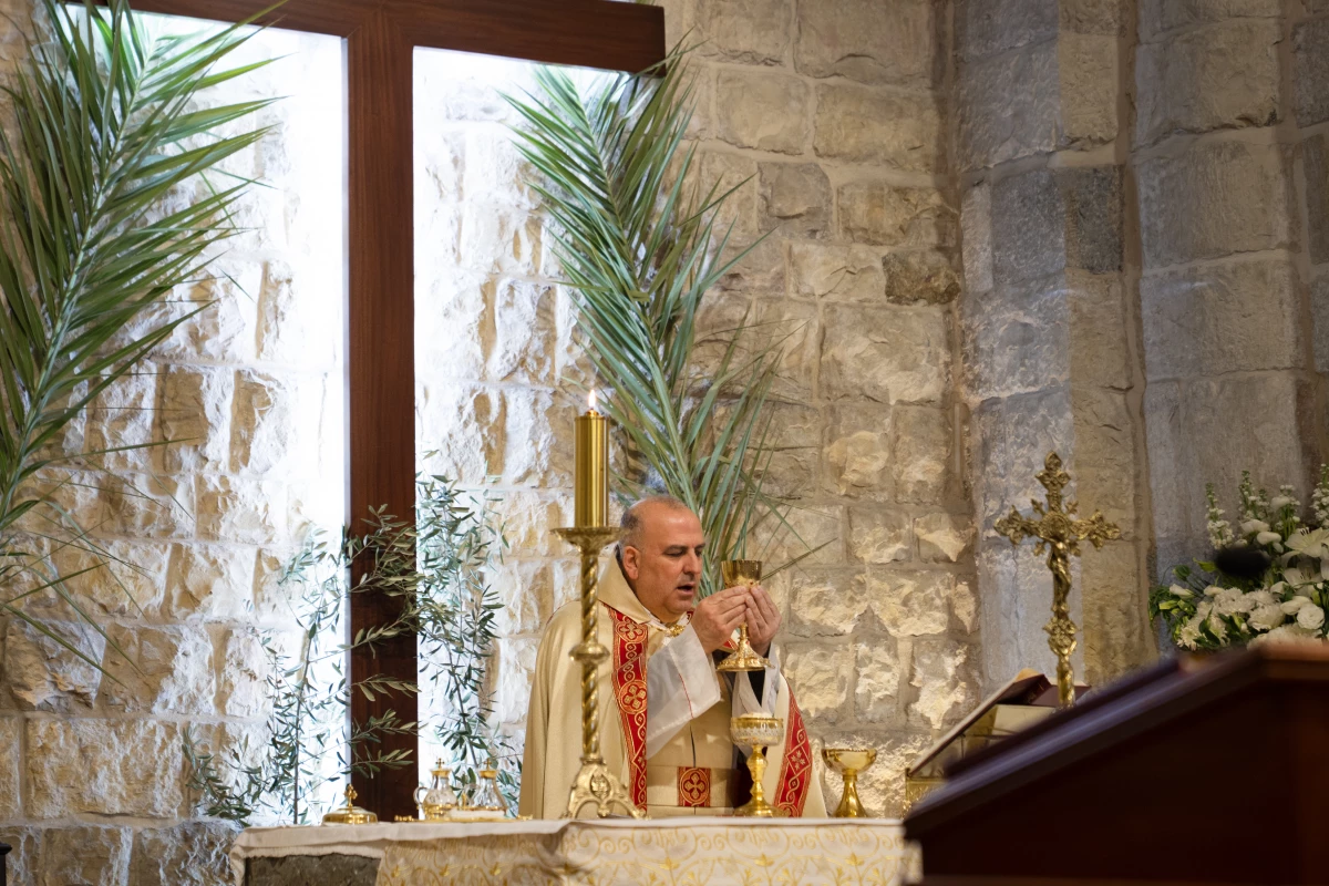 Father Elias El Helou presides over mass on Palm Sunday at St. Maron Church in Jezzine.