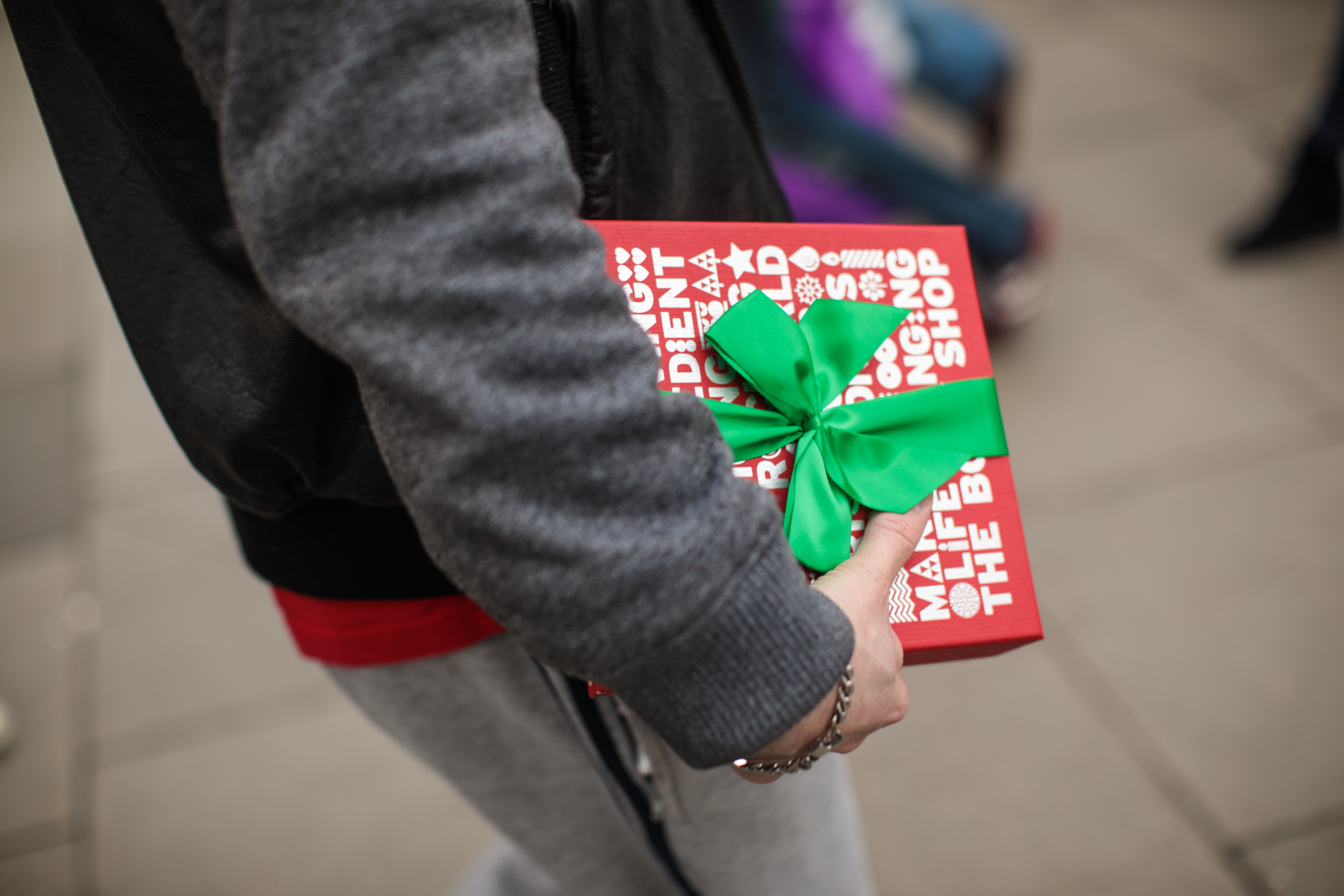 A man carries a gift-wrapped box on Oxford Street on December 24, 2016 in London, England. Christmas shoppers hunt for last minute presents in central London on Christmas Eve.