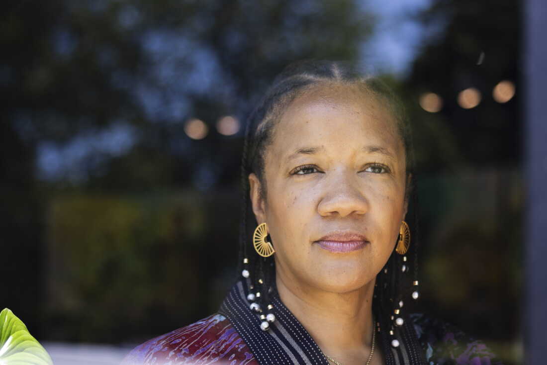 Photographed from about the shoulders up, Robin Rue Simmons is in the entryway of FirstRepair, the nonprofit she founded.