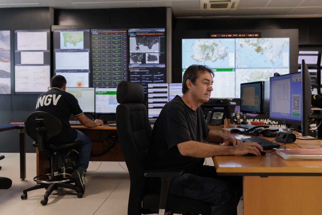 Giovanni Macedonio, geophysicist and research director at INGV, one of the scientists of the National Institute of Geophysics and Volcanology engaged in the continuous monitoring of the Campi Flegrei Caldera, working at a computer station in the laboratory: 'This seismicity is a phenomenon of volcanic origin. Beneath the Campi Flegrei, at a shallow depth between 1 and 3 km, there is a hydrothermal system: fractured rock with water that is heated by deep gases rising from magma about 10 km below. This high-temperature steam, around 1000 degrees, heats the reservoir, pressurizes the hydrothermal system. This process produces degassing, ground uplift, and earthquakes.'