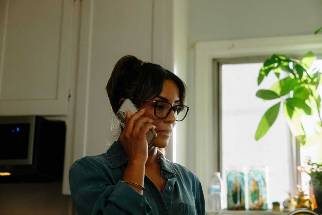 Jessica Serrato talks on the phone to her boyfriend, who is reservist and is currently deployed to the Middle East, while she gets her children ready for school in Southern California.