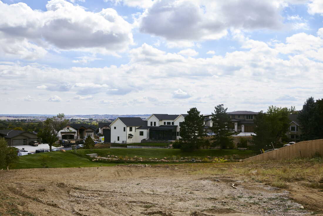 A newly rebuilt home stands next to an empty lot in the Louisville neighborhood. Wildfires are among the climate-related impacts Boulder County cites in its lawsuit against ExxonMobil and Suncor Energy.