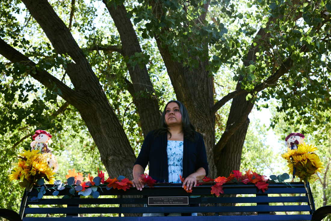 Montoya stands behind a bench, on a trail near her home, in memory of Juliana.