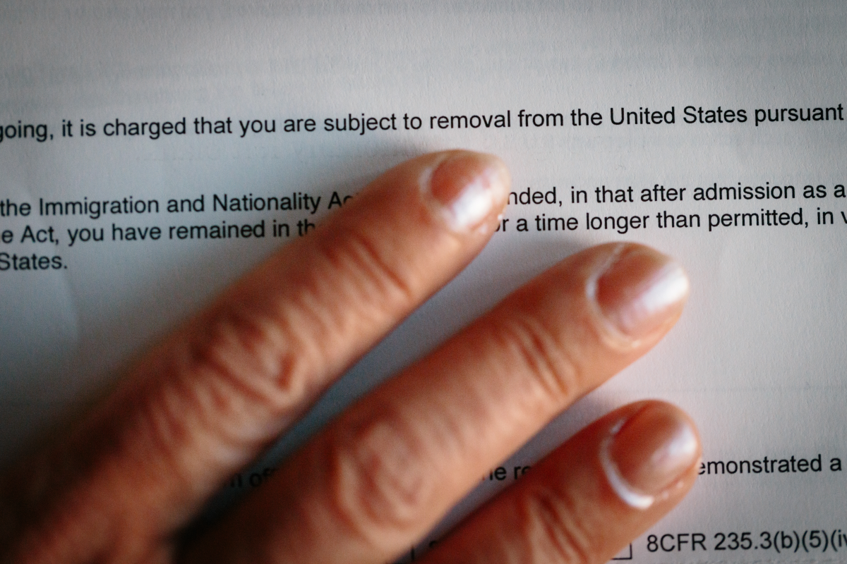 An adoptee brought to the United States by her American parents from Iran as a young child holds the immigration removal order she received recently, photographed in California on Feb. 21.