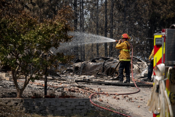 The Spokane Complex Fires have burned over 900 structures and over 10,000 acres as the fires continue for a sixth day on August 6, 2026 in one of the biggest fires in Washington State history. Firefighters visit burned homes to put out hot spots on the properties to prevent new blazes.