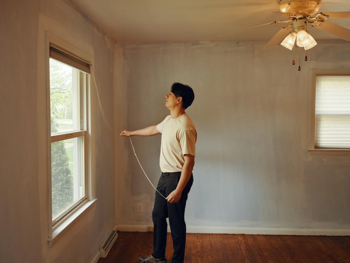 Vazquez has spent hours fixing up the house before moving in, including tearing out carpet and sanding and staining the hardwood floors. (Caleb Alvarado/NPR)