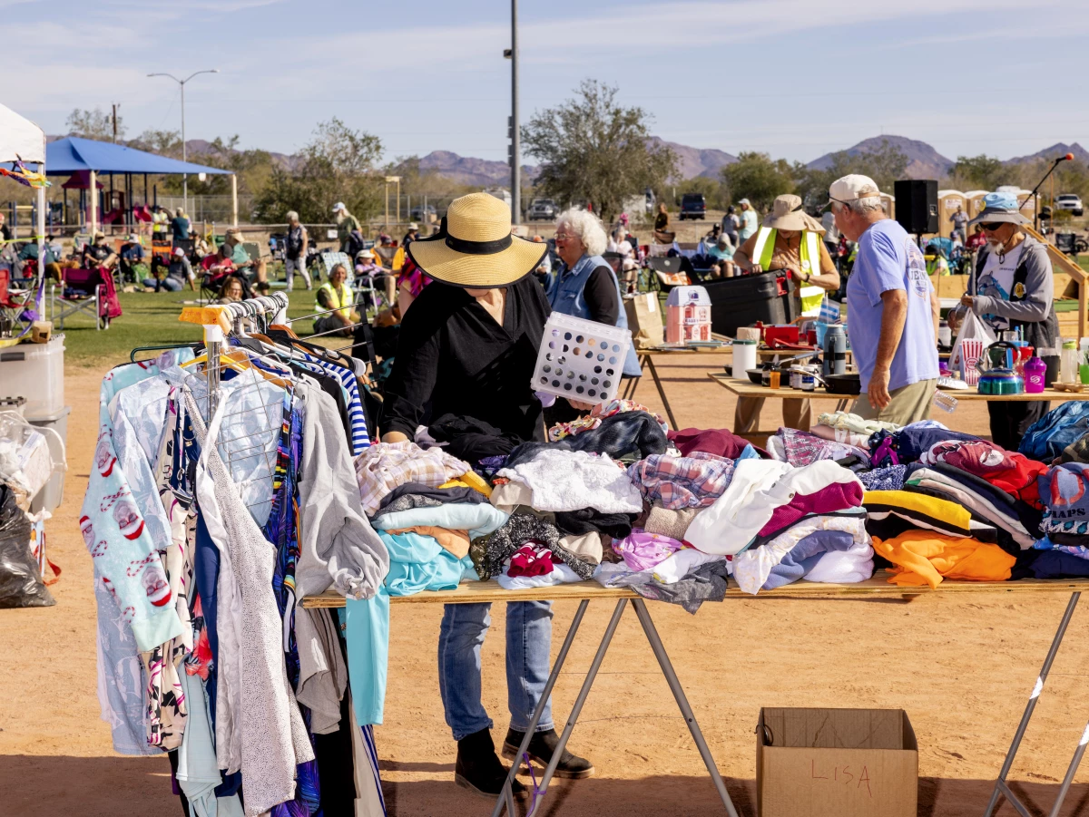 An attendee browses the free tables, where people bring clothing, books and cookware to share.
