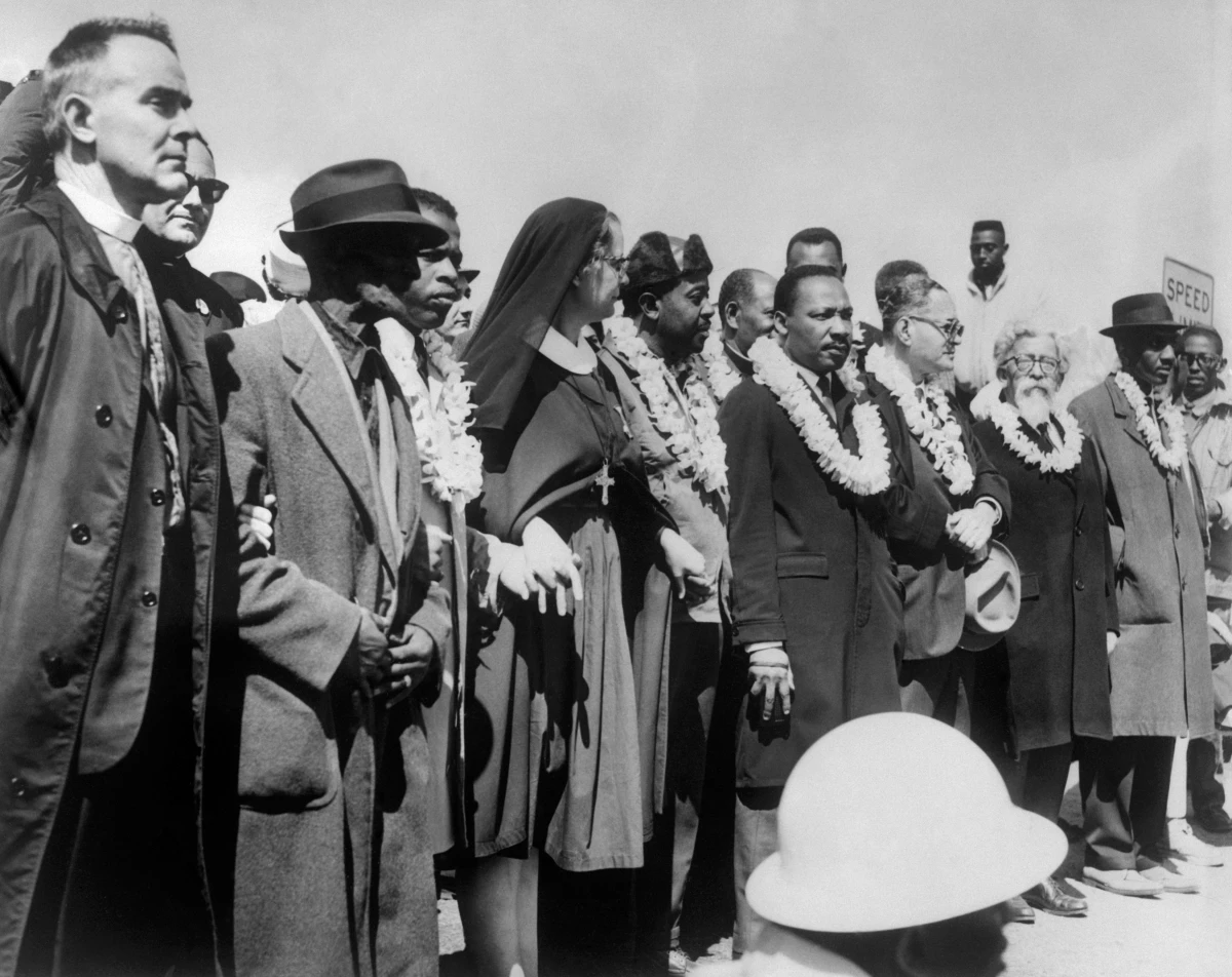 Civil rights demonstrators, led by Dr. Martin Luther King (5th R), civil rights activist Ralph Abernathy (5th L), John Lewis (3rd L) and other civil and religious leaders, make their way from Selma to Montgomery on March 22, 1965 in Alabama.